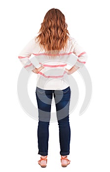 Back view of standing young beautiful redhead woman
