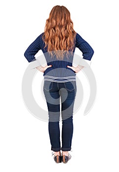 Back view of standing young beautiful redhead woman