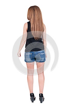 Back view of standing young beautiful redhead woman.