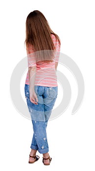 Back view of standing young beautiful redhead woman.