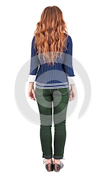Back view of standing young beautiful redhead woman.