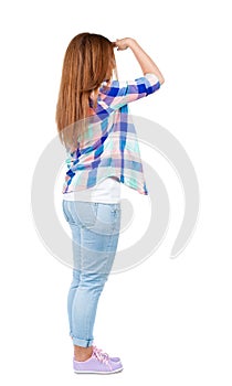 Back view of standing young beautiful redhead woman.