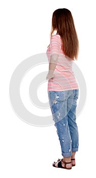 Back view of standing young beautiful redhead woman.