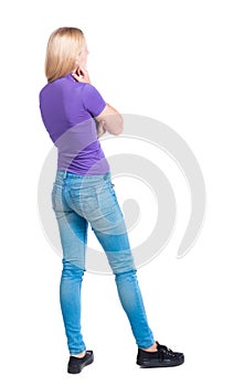 Back view of standing young beautiful woman