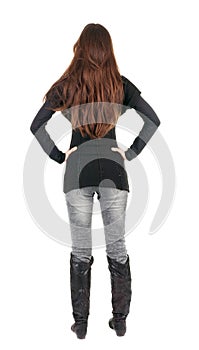 Back view of standing young beautiful woman.