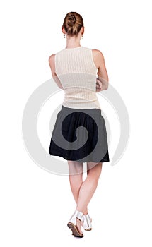 Back view of standing young beautiful woman.