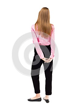 Back view of standing young beautiful woman.