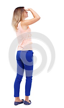 Back view of standing young beautiful woman