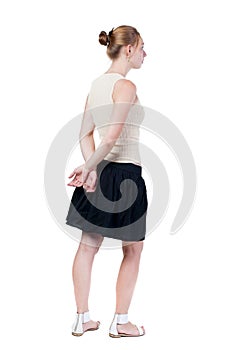 Back view of standing young beautiful woman.