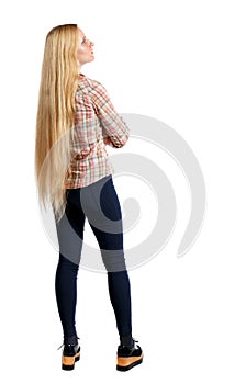 Back view of standing young beautiful woman.