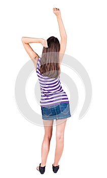 Back view of standing young beautiful woman thumbs up.