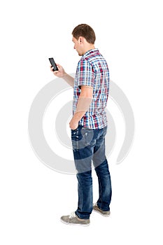 Back view of standing young men and using a mobile phone