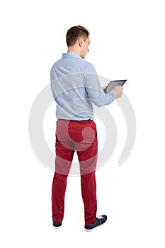 Back view of standing young men and using a tablet.