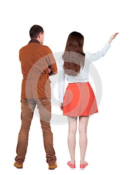 Back view of a stylish couple pointing