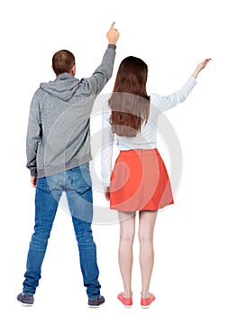 Back view of a stylish couple pointing