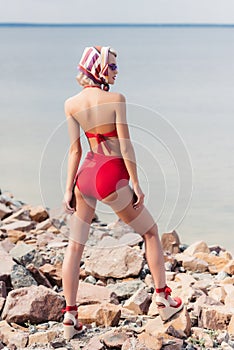 back view of stylish girl posing in red bikini