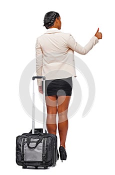 Back view of stylishly dressed business black woman with suitcase shows thumb up