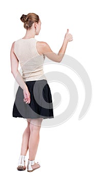 Back view of successful woman thumbs up