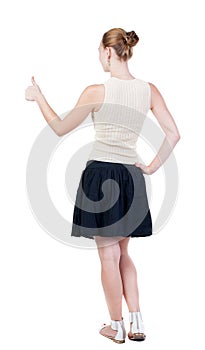 Back view of successful woman thumbs up