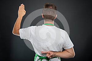 Back view of supermarket employer making fake oath gesture