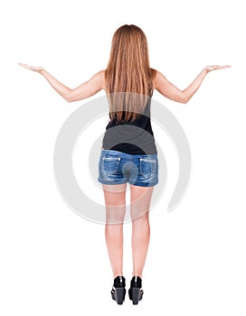 Back view of surprised beautiful young redhead woman with hands
