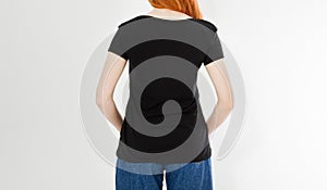 Back view t-shirt design, happy people concept - smiling red hair woman in blank black t-shirt pointing her fingers at herself,