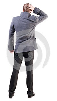 Back view of thinking business man in coat