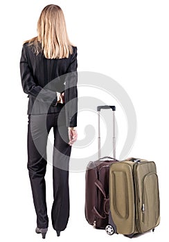 Back view of thoughtful business woman traveling with suitcas.