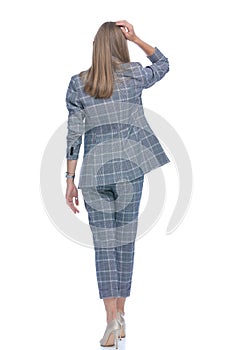 Back view of thoughtful businesswoman scratching head