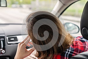 Back view of tired Woman passenger traveling by car on the highway . Freedom concept.