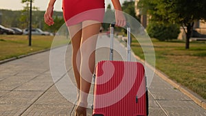 Back view of tourist traveler woman legs in red dress