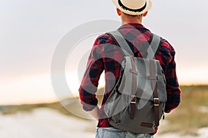 Back view, traveler man , raising his hands up on the trail on the top of the mountain, Tourist on top of high rocks