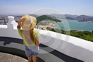 Back view of traveler woman enjoying landscape of Vitoria metropolitan region, Espirito Santo, Brazil