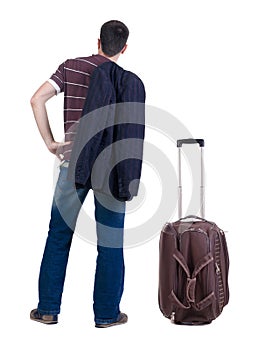 Back view of traveling busness man with suitcase