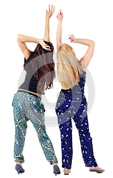Back view of two beautiful young woman dancing
