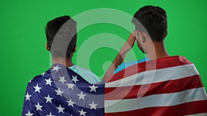 Back view two disappointed football fans wrapped in USA flag gesturing talking on green screen. Unsatisfied Middle