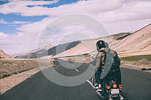 back view of two motorcyclists on mountain road in Indian Himalayas,