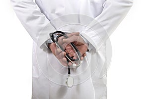 Back view of unidentified male medicine doctor holding stethoscope in his hand wearing medical gown