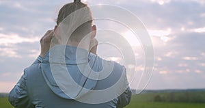 Back view of unrecognizable man observing landscape in binoculars copy text space. Detailed macro portrait of traveler