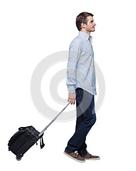 Back view of walking  business man  with suitcase