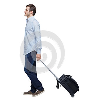 Back view of walking  business man  with suitcase