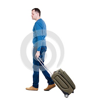 Back view of walking man with suitcase.