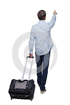 Back view of walking pointing business man with suitcase