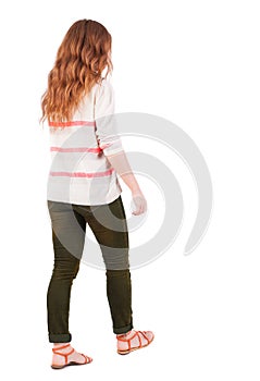 Back view of walking woman