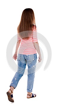 Back view of walking woman .