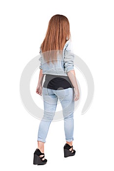 Back view of walking woman.