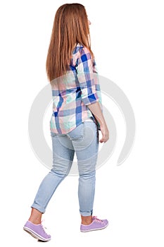 Back view of walking woman.