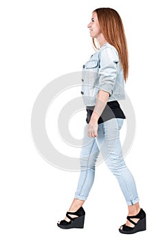 Back view of walking woman.