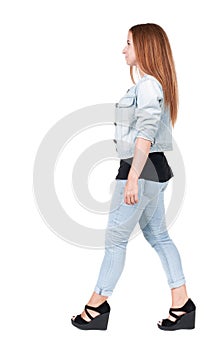 Back view of walking woman.