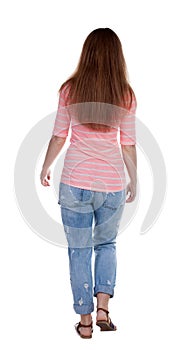 Back view of walking woman .